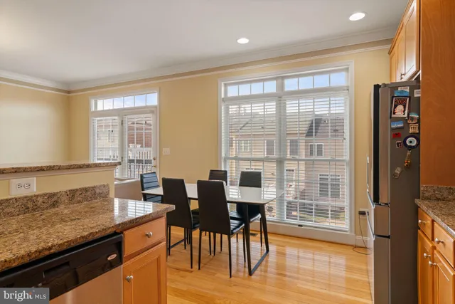 a view of a a dining room with furniture window and wooden floor