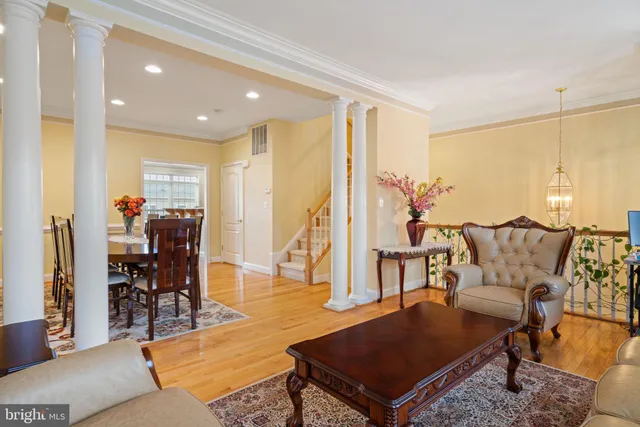 a living room with furniture a rug and a chandelier