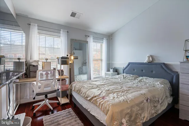 a bed sitting in a bedroom next to a window
