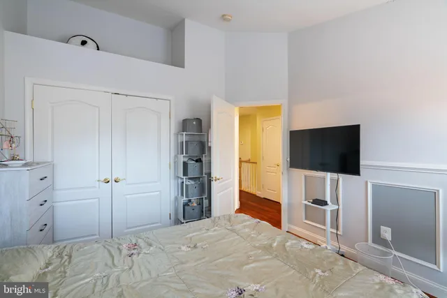 a view of a bedroom with a flat screen tv and closet