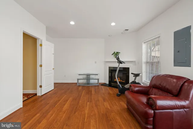 a view of a livingroom with furniture and a gym machine