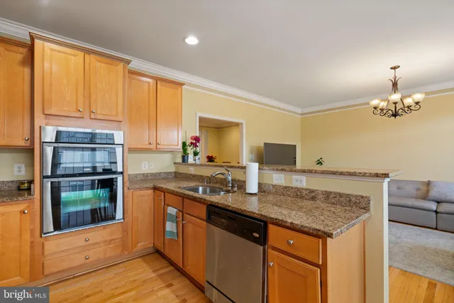 a kitchen with kitchen island granite countertop a counter space a sink and cabinets
