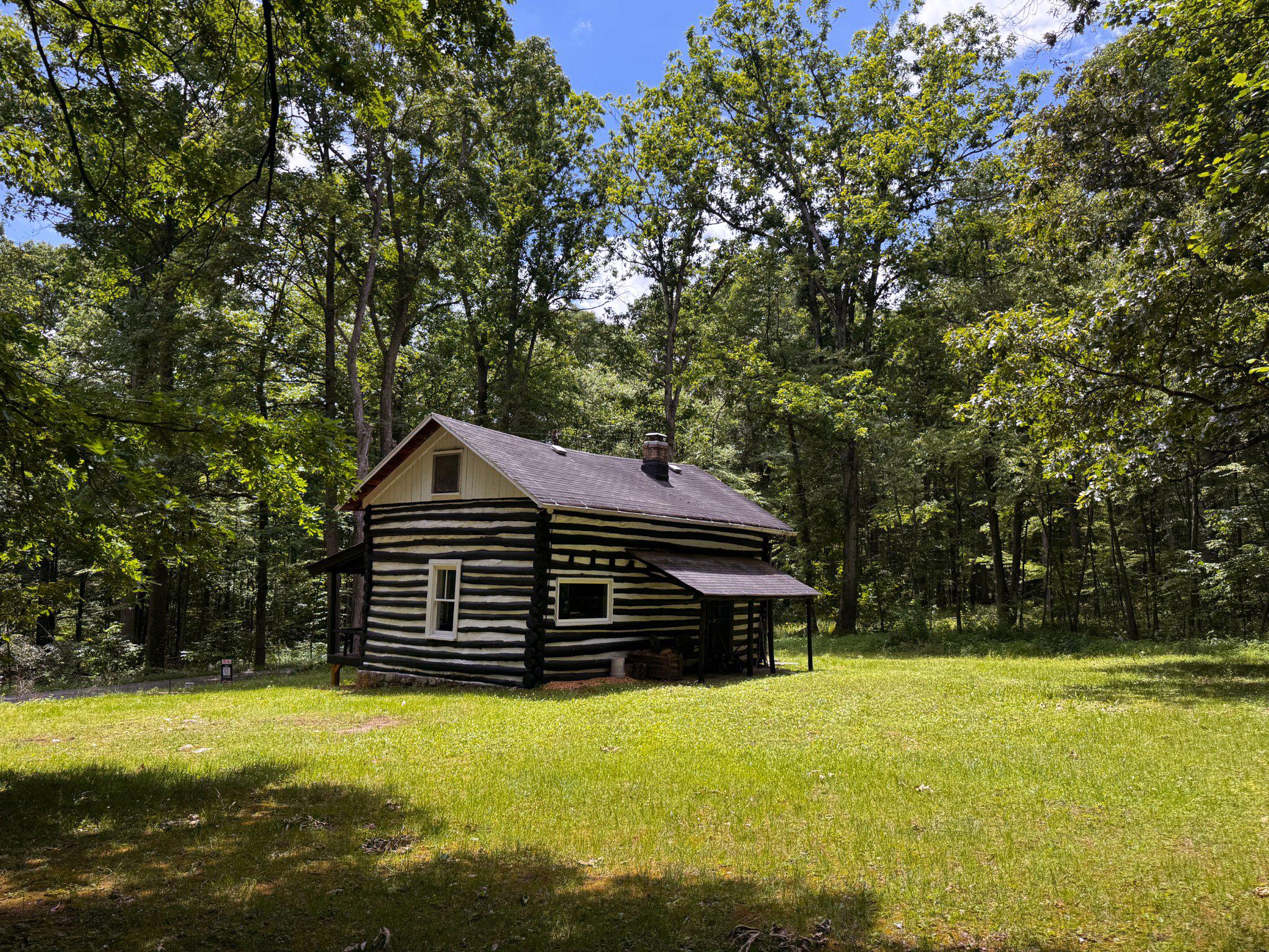4464 Tram Road Spruce Creek, PA 16683 - Photo 41 of 53 a front view of house with yard and trees in the background