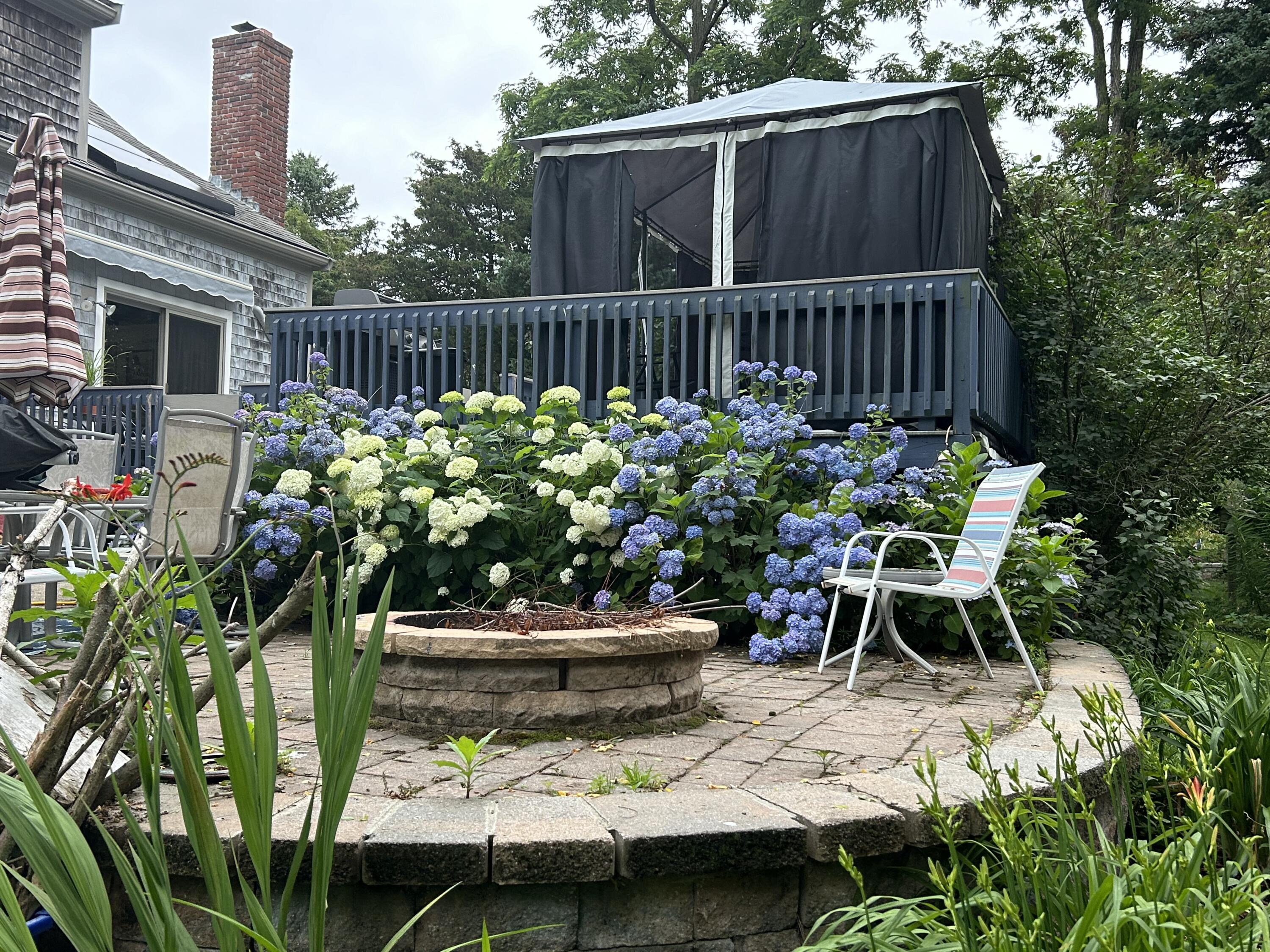 9 Bittersweet Road East Falmouth, MA 02536 - Photo 15 of 24 a view of a chair and table in the backyard