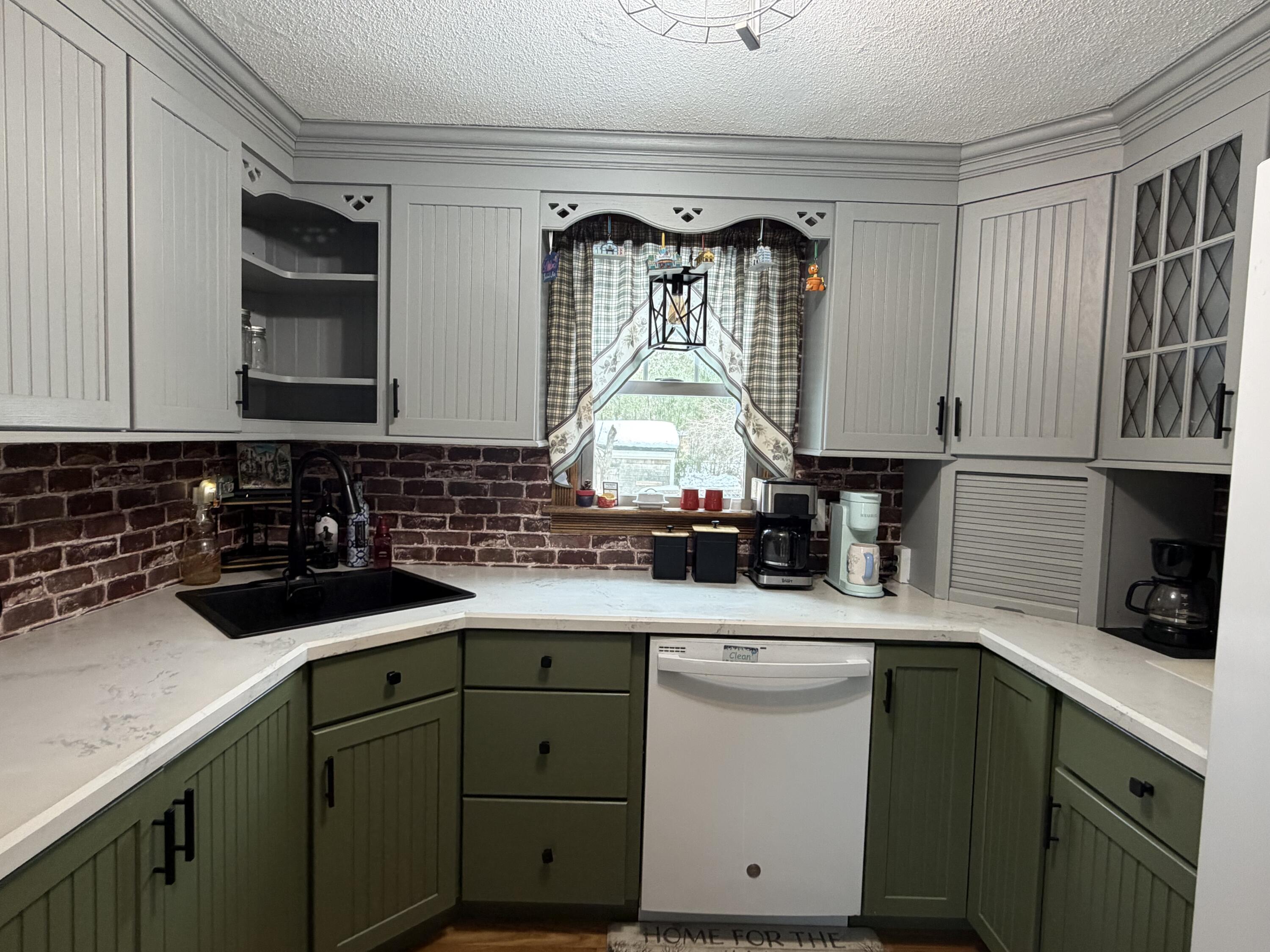 9 Bittersweet Road East Falmouth, MA 02536 - Photo 4 of 24 a kitchen with a sink dishwasher a stove and cabinets