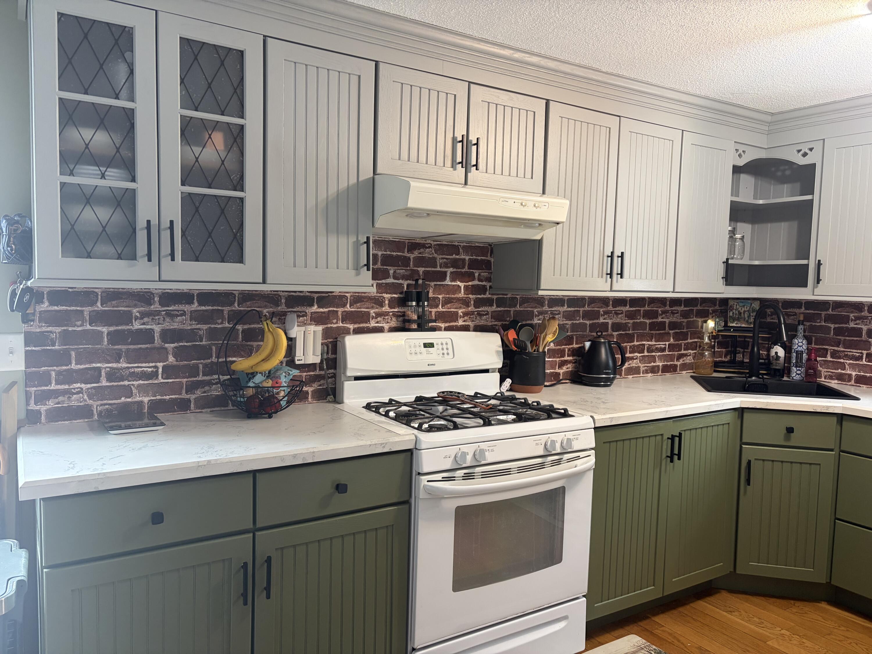 9 Bittersweet Road East Falmouth, MA 02536 - Photo 7 of 24 a kitchen with stainless steel appliances granite countertop a sink stove and cabinets