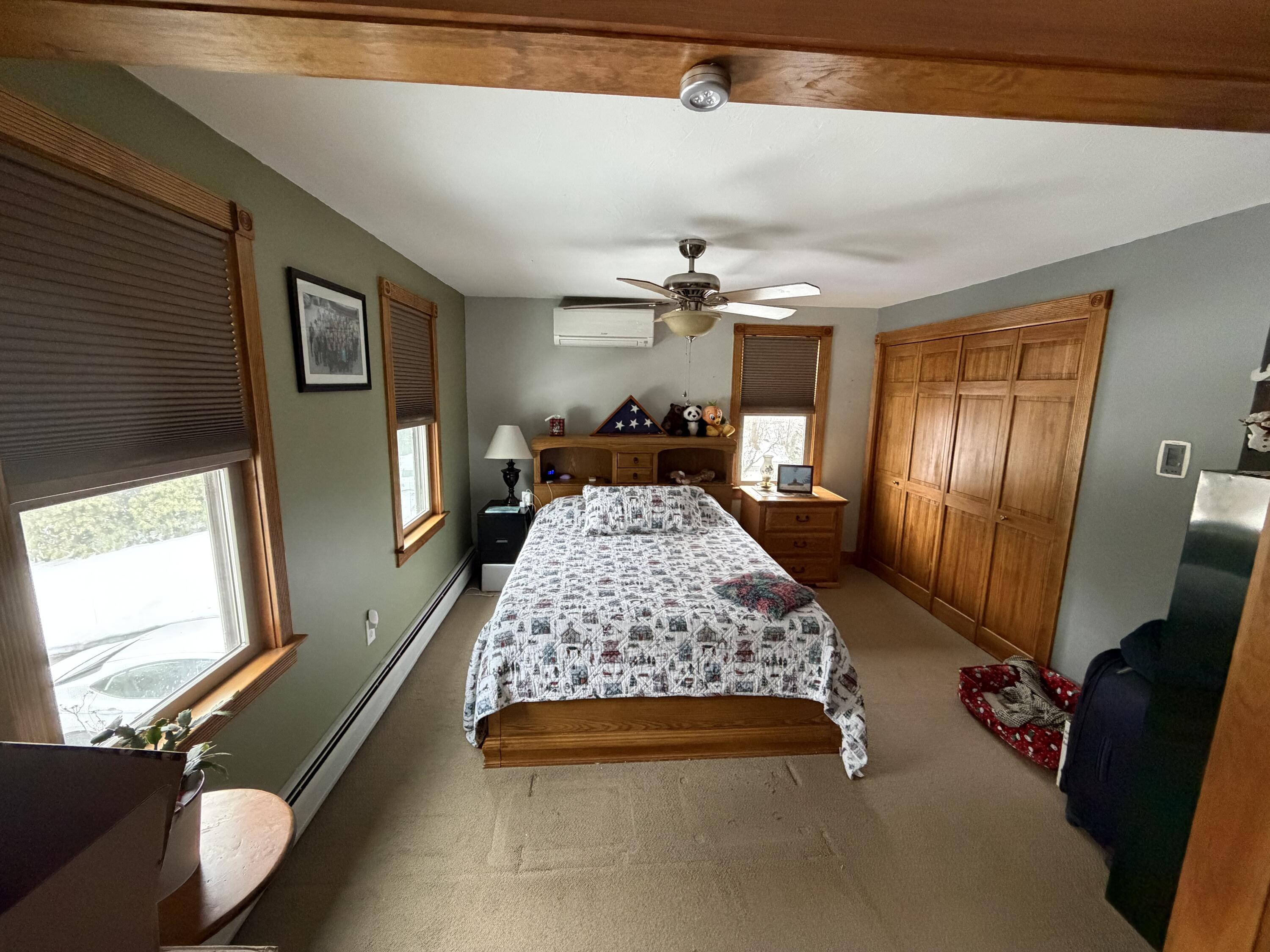 9 Bittersweet Road East Falmouth, MA 02536 - Photo 8 of 24 a bed room with a bed furniture and a flat tv screen