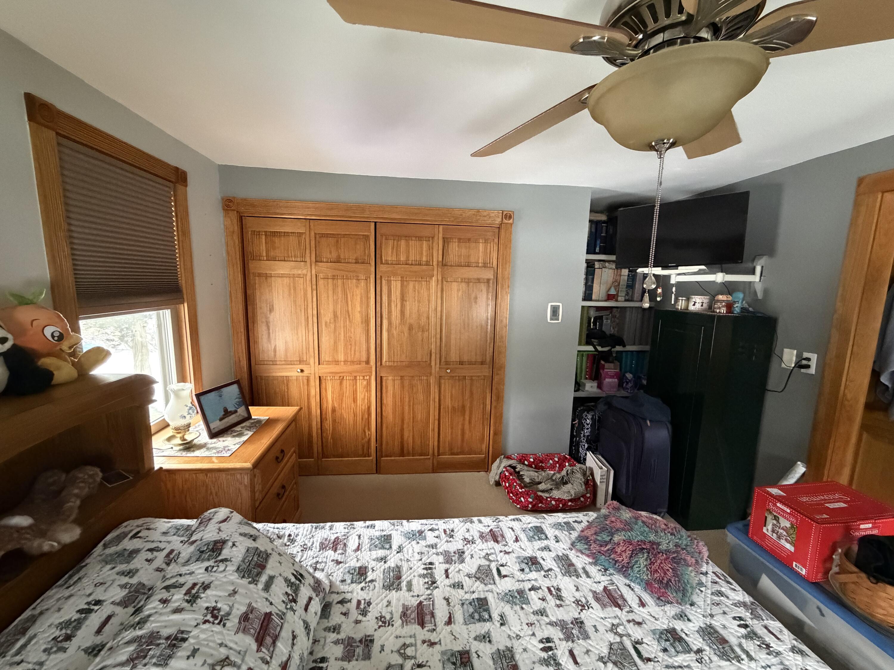 9 Bittersweet Road East Falmouth, MA 02536 - Photo 9 of 24 a bedroom with a bed and a chandelier