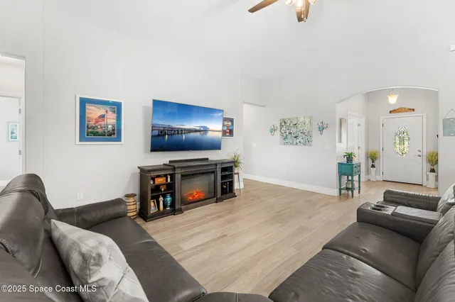 a view of a living room kitchen and a wooden floor