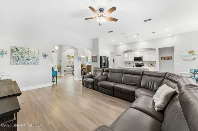 a spacious bathroom with a granite countertop sink a mirror and a bathtub
