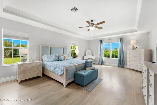 a spacious bathroom with a granite countertop sink a mirror a vanity and a shower
