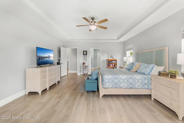a spacious bathroom with a granite countertop sink a toilet a mirror and shower