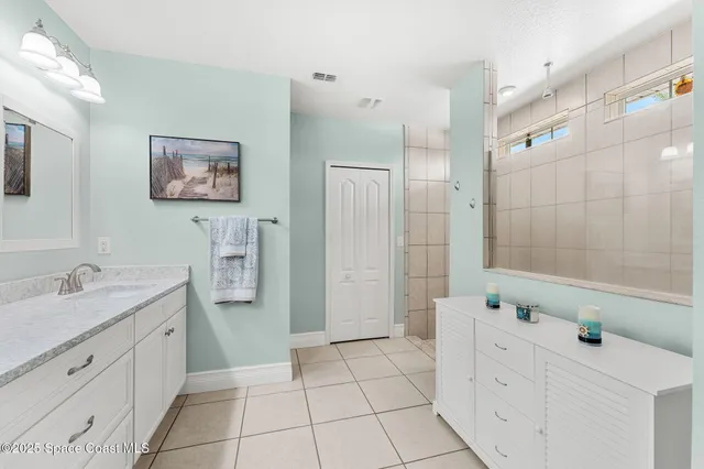 a bathroom with a granite countertop sink mirror vanity and toilet