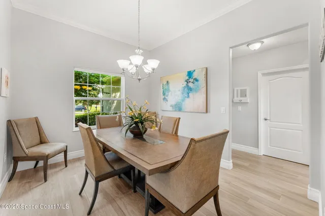 a view of a dining room with furniture and chandelier