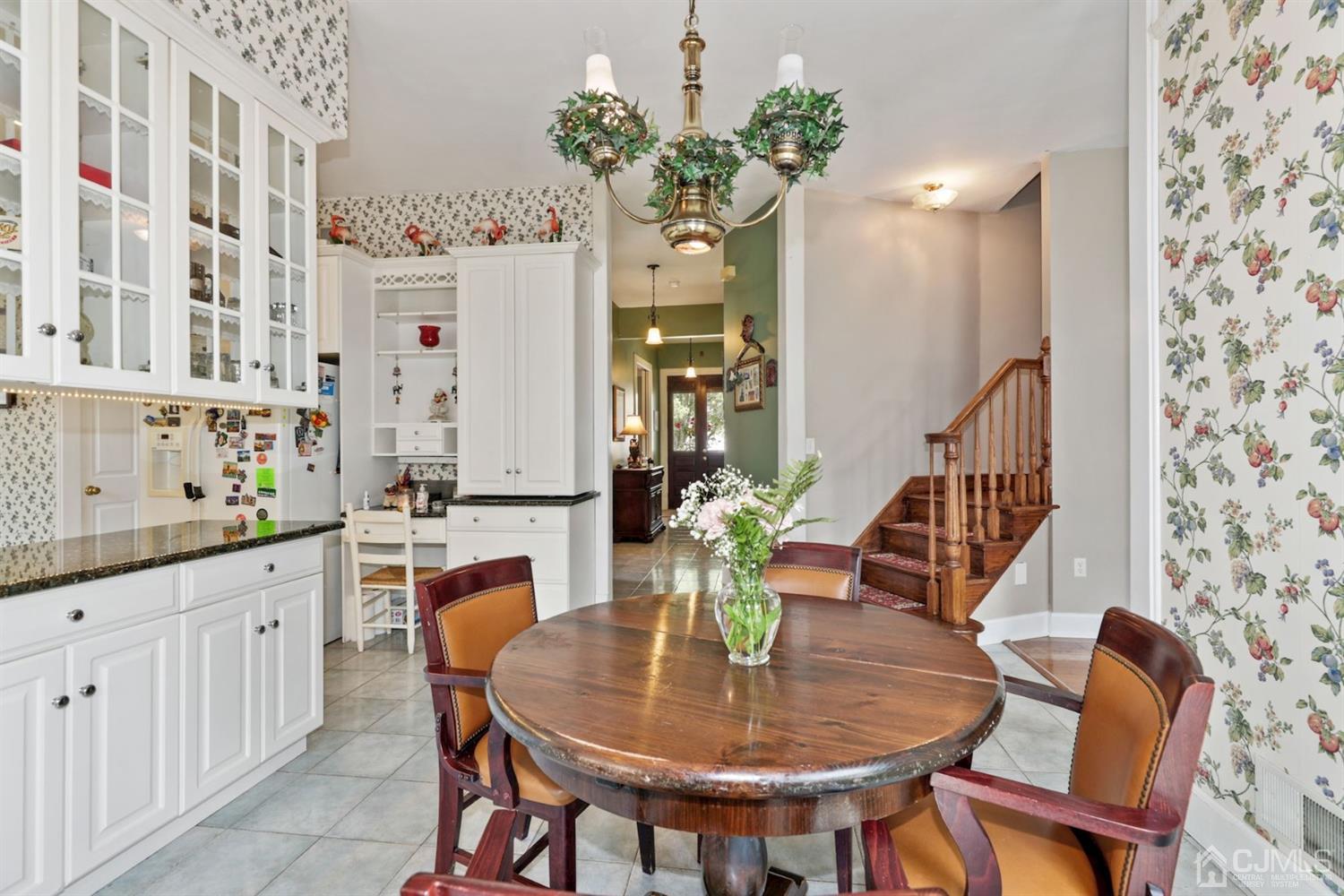 89 Elm Street Colonia, NJ 07067 - Photo 11 of 29 a dining room with furniture potted plants and wooden floor