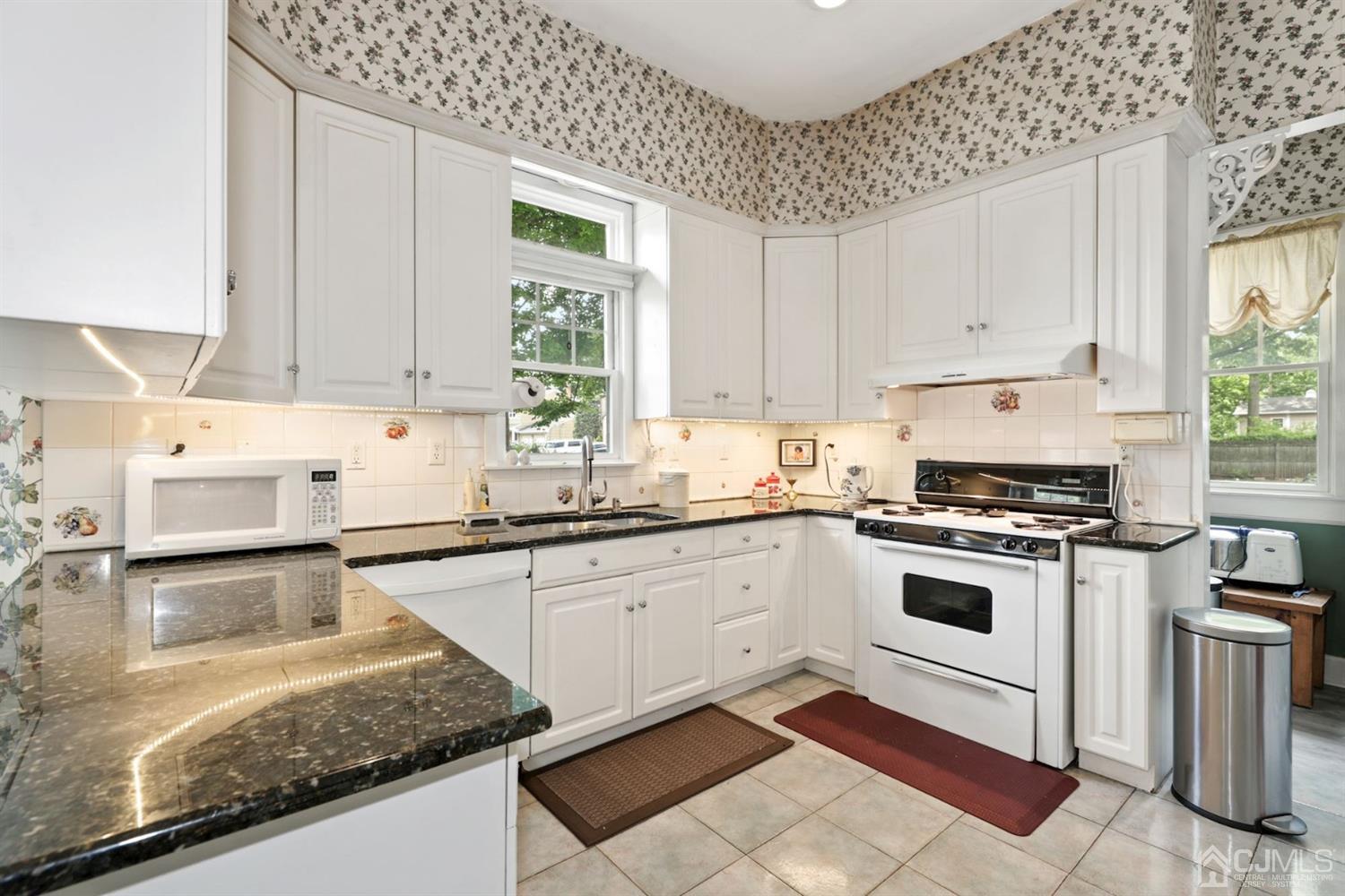 89 Elm Street Colonia, NJ 07067 - Photo 13 of 29 a white kitchen with granite countertop a stove sink and cabinets