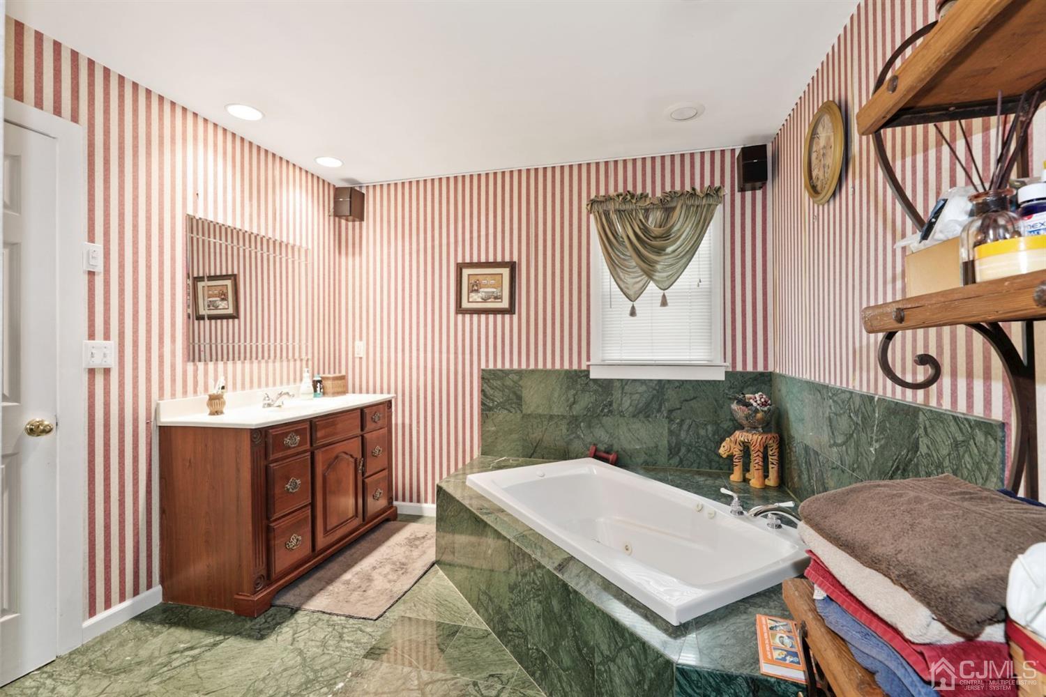 89 Elm Street Colonia, NJ 07067 - Photo 16 of 29 a bath room with a sink and a mirror