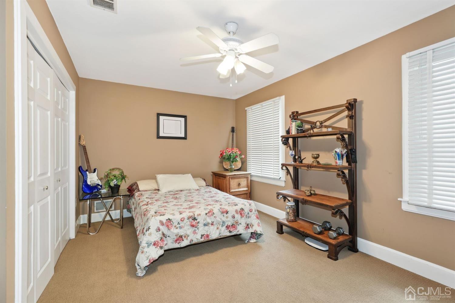 89 Elm Street Colonia, NJ 07067 - Photo 18 of 29 a bedroom with a bed and a chandelier