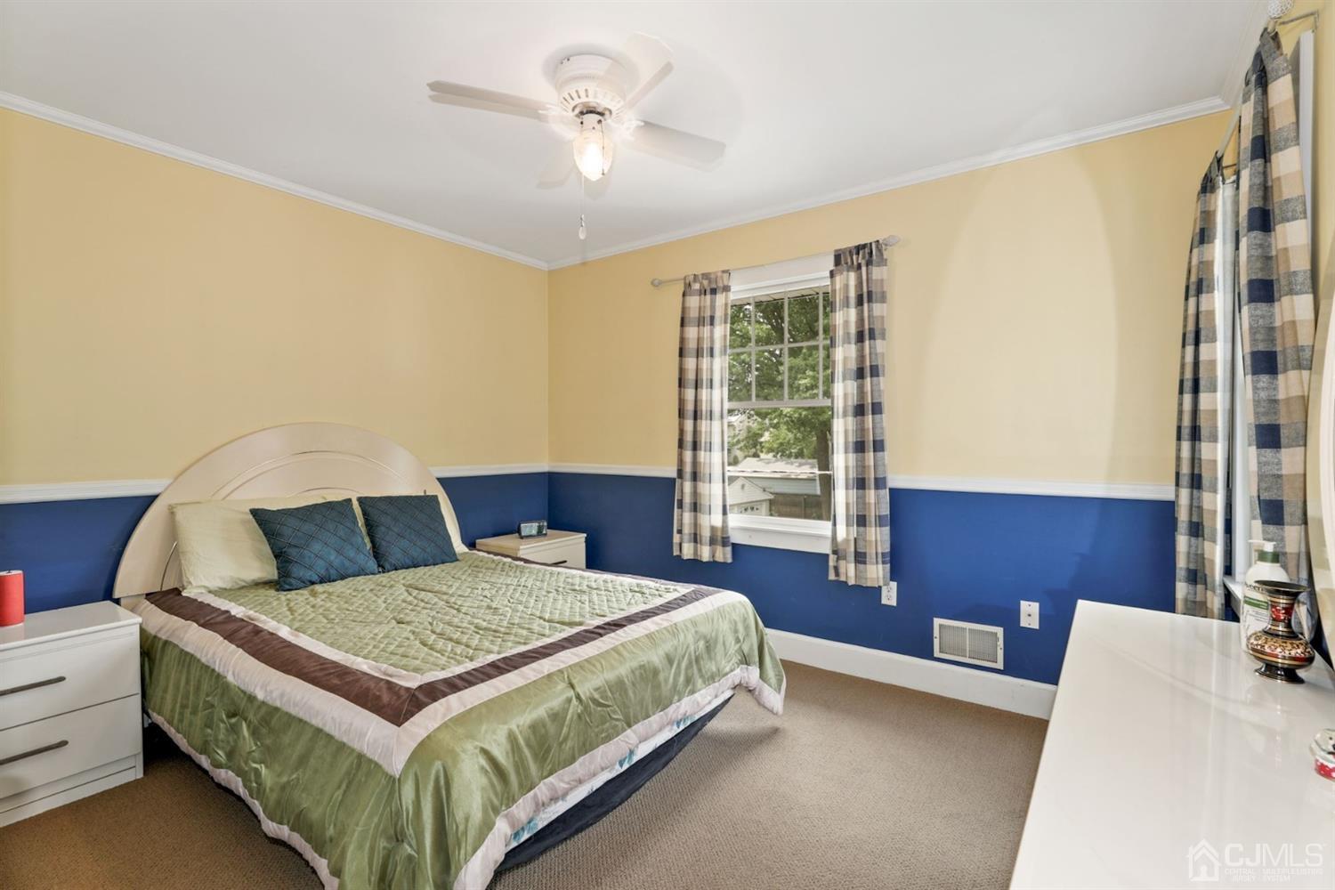 89 Elm Street Colonia, NJ 07067 - Photo 19 of 29 a bedroom with a bed and a table in it