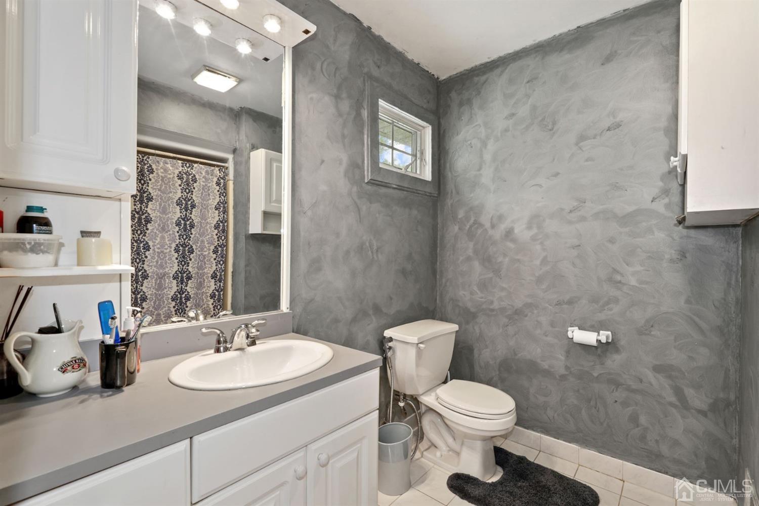 89 Elm Street Colonia, NJ 07067 - Photo 21 of 29 a bathroom with a sink toilet and a mirror