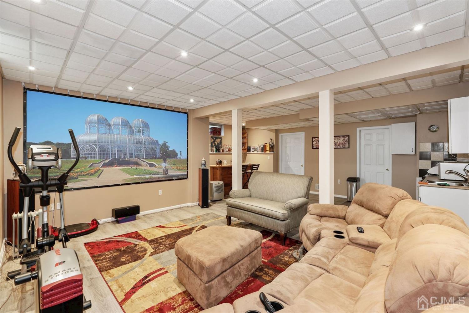 89 Elm Street Colonia, NJ 07067 - Photo 23 of 29 a living room with furniture a window and a flat screen tv