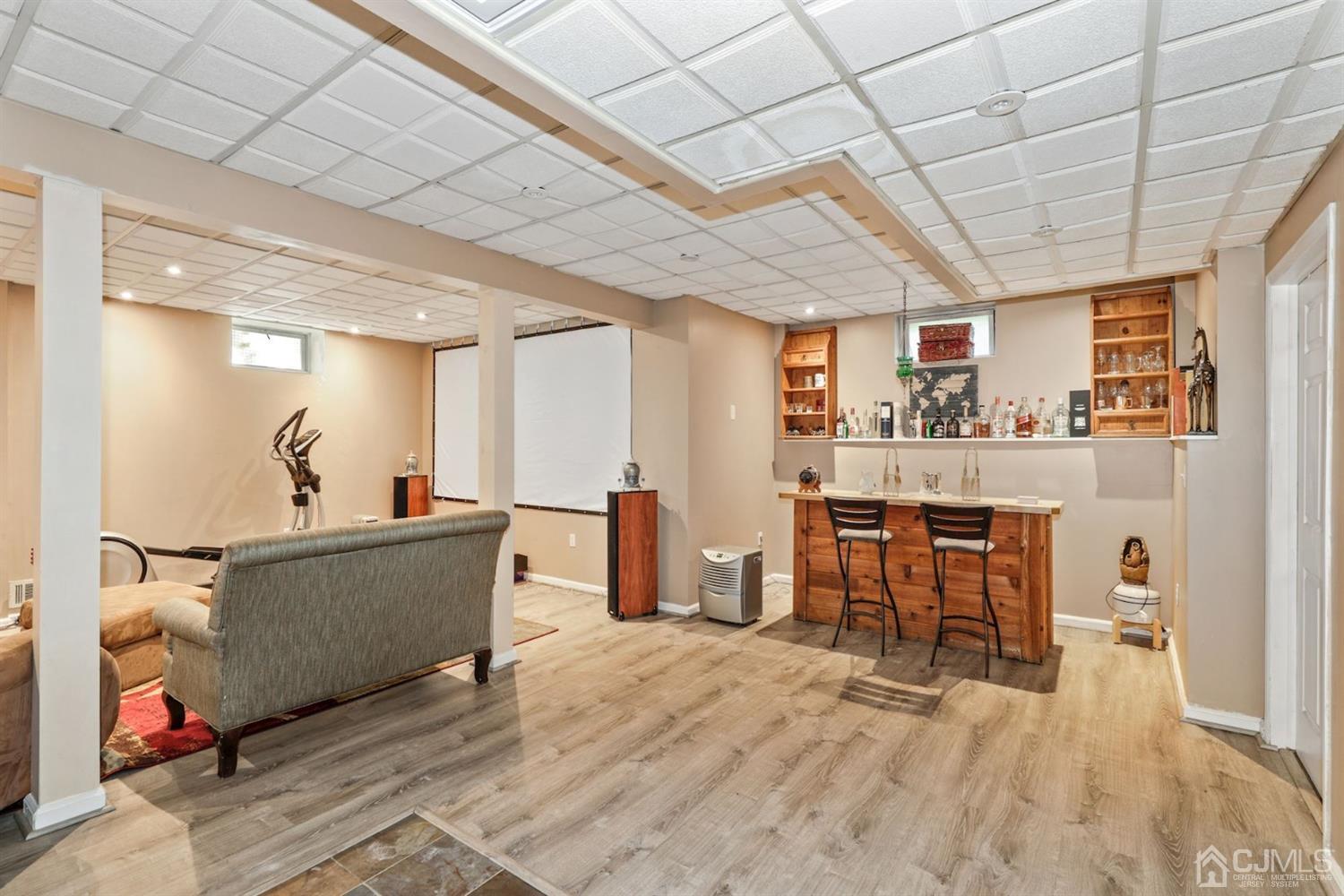 89 Elm Street Colonia, NJ 07067 - Photo 24 of 29 a living room with furniture and a wooden floor
