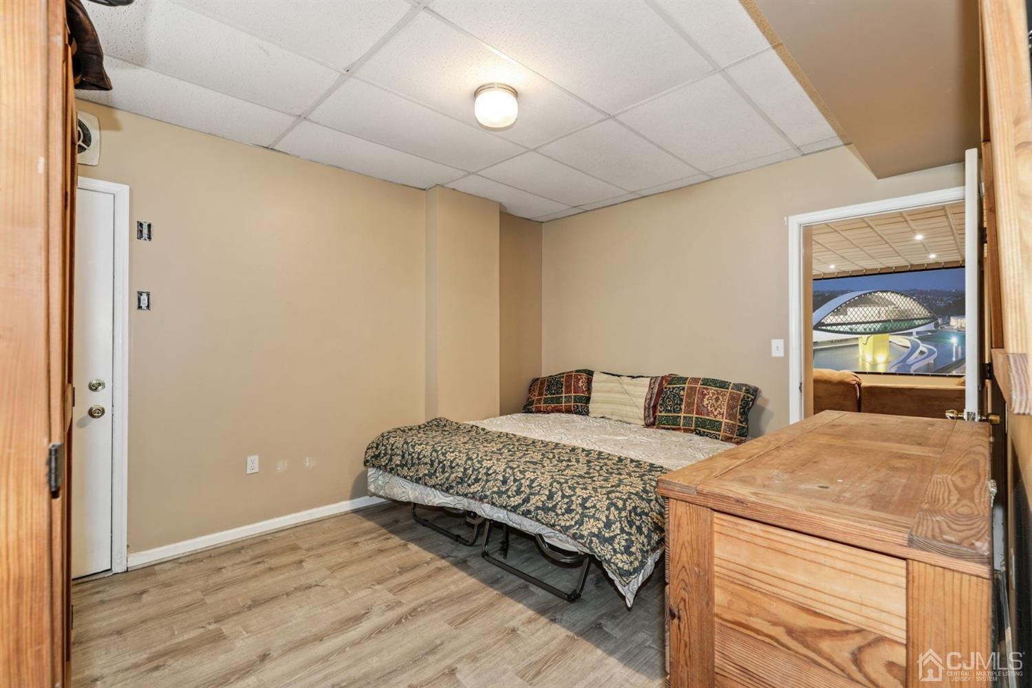 89 Elm Street Colonia, NJ 07067 - Photo 26 of 29 a bedroom with a bed and a painting on the wall