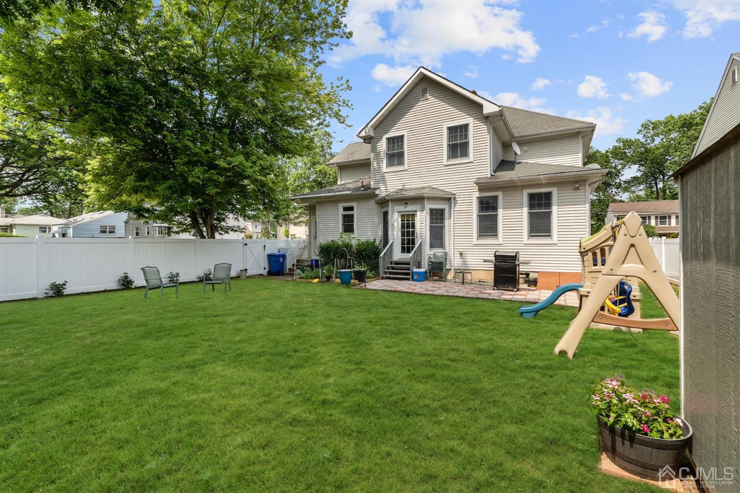 89 Elm Street Colonia, NJ 07067 - Photo 28 of 29 a view of a house with a backyard porch and sitting area