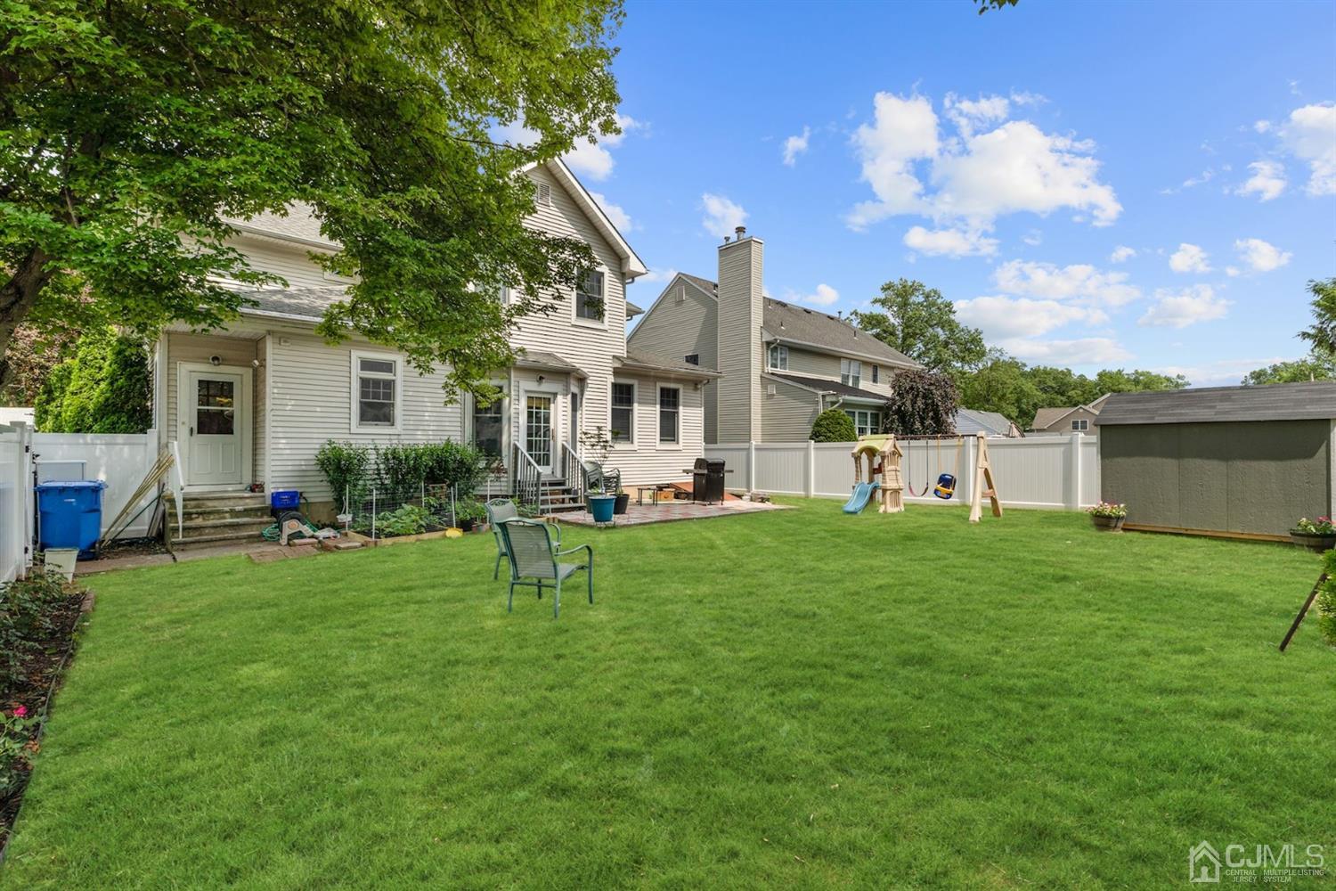 89 Elm Street Colonia, NJ 07067 - Photo 29 of 29 a front view of house with yard and green space