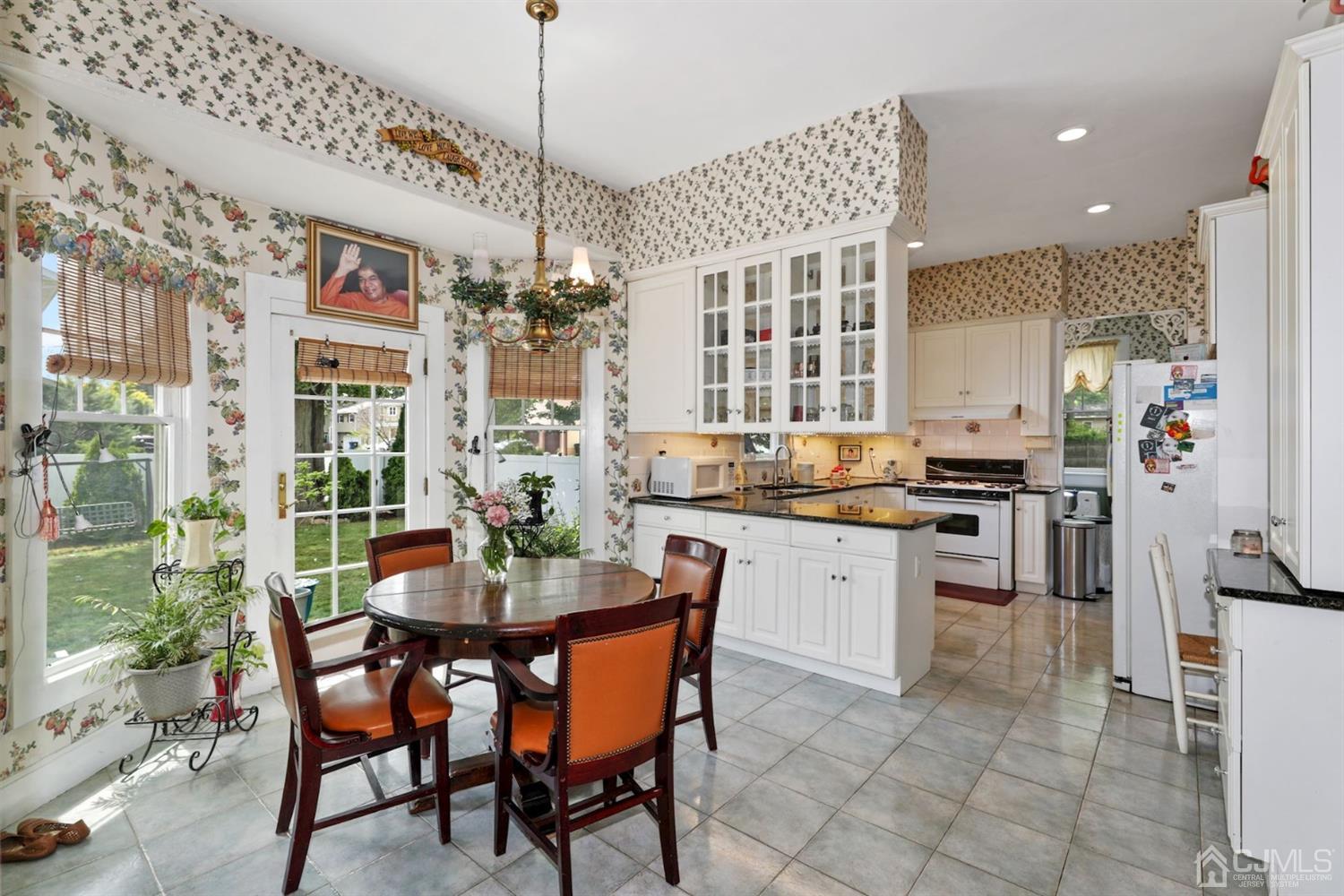 89 Elm Street Colonia, NJ 07067 - Photo 10 of 29 a kitchen with a dining table chairs stainless steel appliances and cabinets