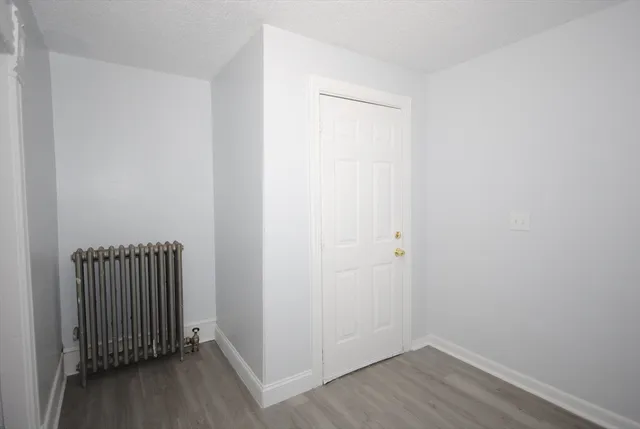 a view of a room with wooden floor