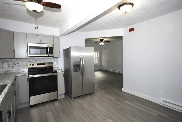 a kitchen with stainless steel appliances a refrigerator and a stove top oven