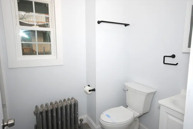 a white toilet sitting next to a bathroom sink
