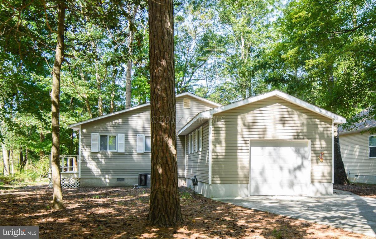 125 Pinehurst Road Ocean Pines, MD 21811 - Photo 1 of 49 a front view of a house with a yard