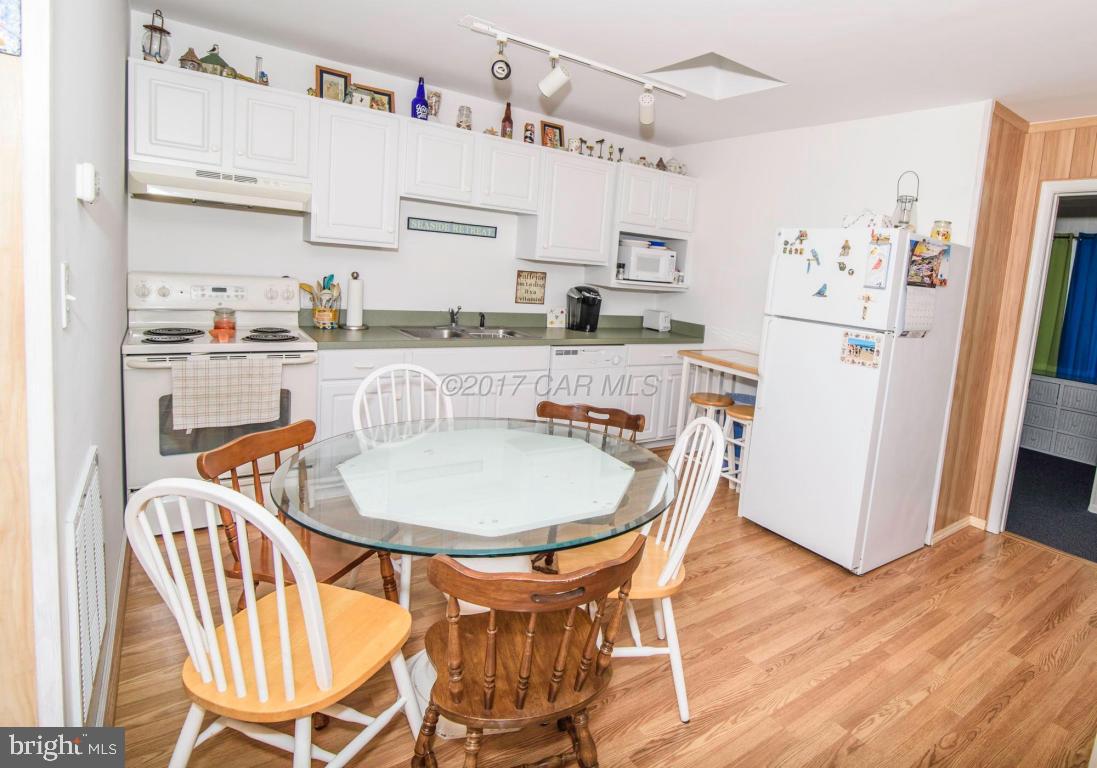 125 Pinehurst Road Ocean Pines, MD 21811 - Photo 12 of 49 a dining room with stainless steel appliances a table and chairs