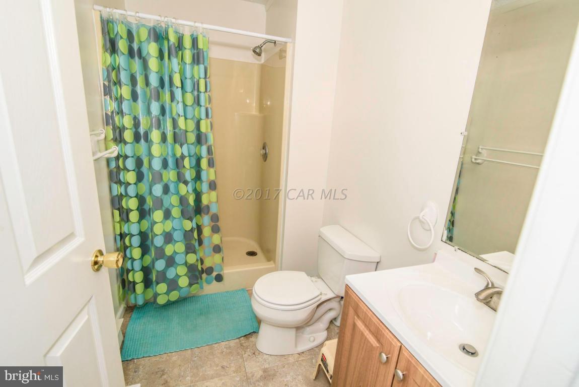 125 Pinehurst Road Ocean Pines, MD 21811 - Photo 14 of 49 a bathroom with a sink a toilet and shower curtain
