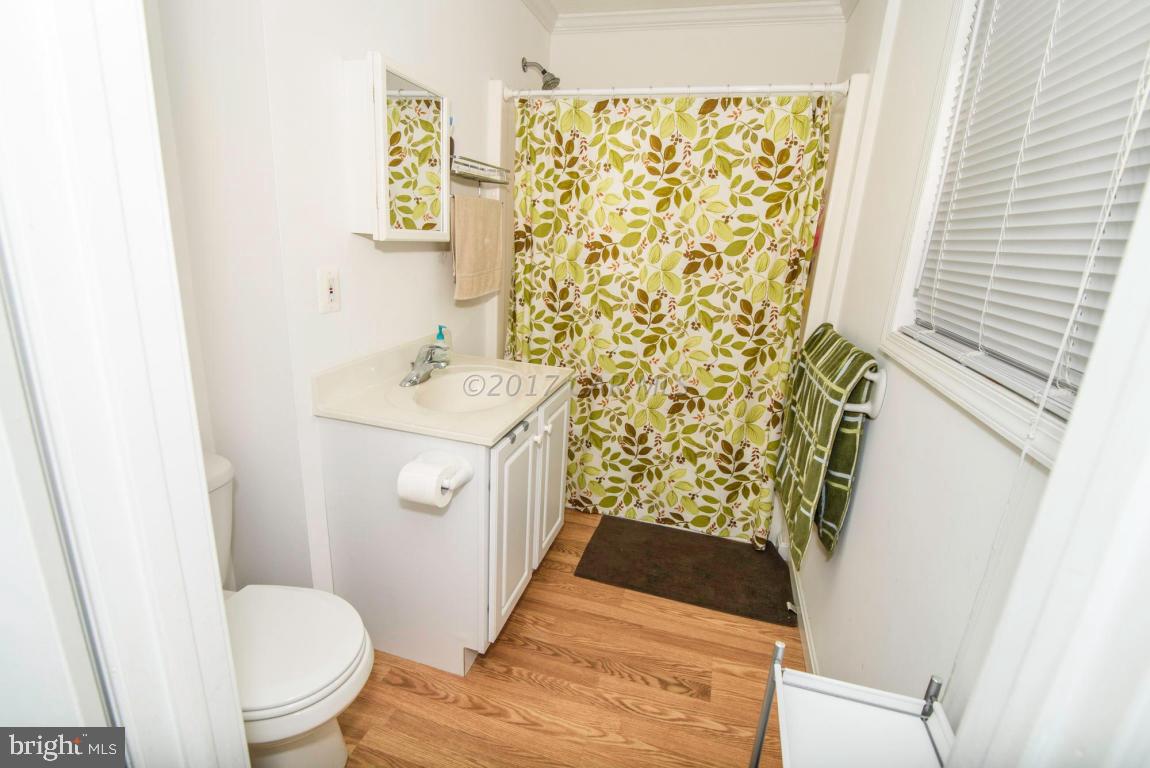 125 Pinehurst Road Ocean Pines, MD 21811 - Photo 19 of 49 a bathroom with a sink toilet and a mirror