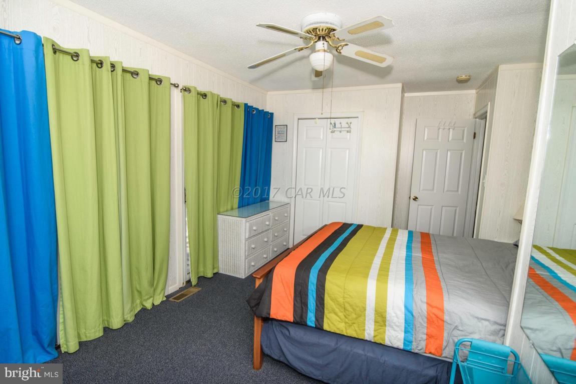 125 Pinehurst Road Ocean Pines, MD 21811 - Photo 21 of 49 a bedroom with a bed and a chandelier