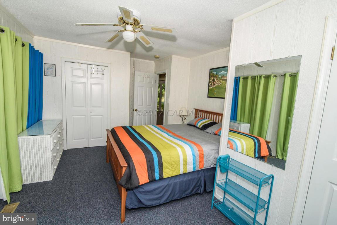 125 Pinehurst Road Ocean Pines, MD 21811 - Photo 23 of 49 a bedroom with a bed and a chandelier