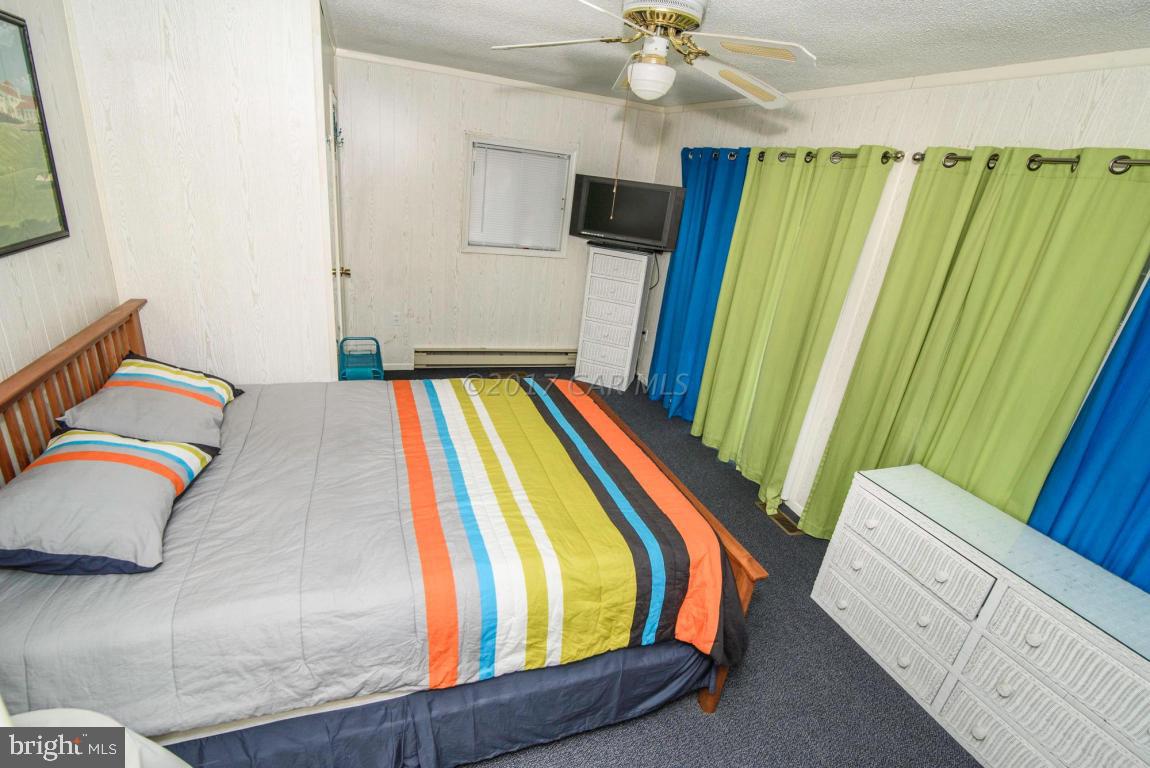 125 Pinehurst Road Ocean Pines, MD 21811 - Photo 24 of 49 a bedroom with a bed and a flat screen tv