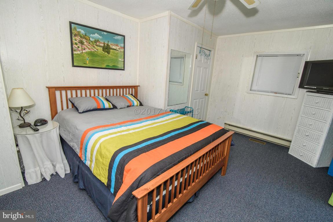 125 Pinehurst Road Ocean Pines, MD 21811 - Photo 29 of 49 a bedroom with a bed and painting on the wall