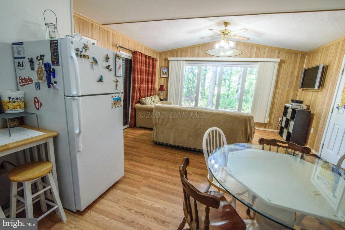125 Pinehurst Road Ocean Pines, MD 21811 - Photo 32 of 49 a kitchen with furniture a refrigerator and a table