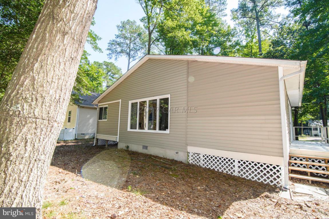 125 Pinehurst Road Ocean Pines, MD 21811 - Photo 48 of 49 a backyard of a house with a large tree