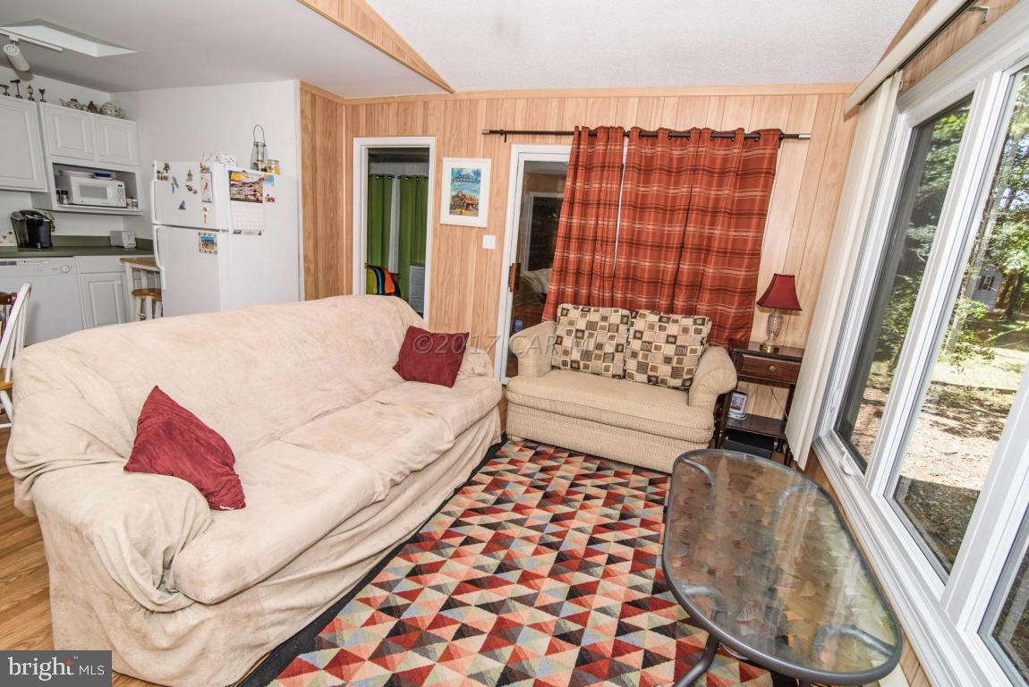 125 Pinehurst Road Ocean Pines, MD 21811 - Photo 8 of 49 a bedroom with a bed and a couch