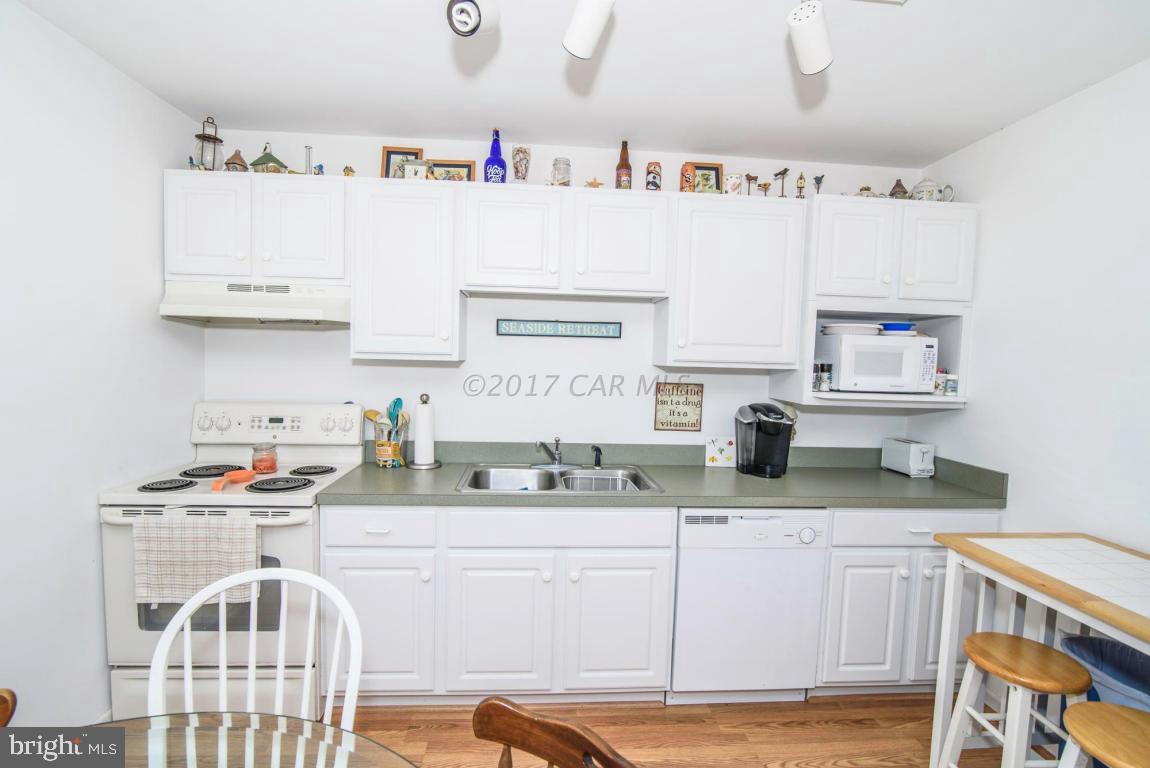 125 Pinehurst Road Ocean Pines, MD 21811 - Photo 10 of 49 a kitchen with stainless steel appliances granite countertop a sink stove and cabinets
