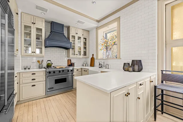 a kitchen with stainless steel appliances a stove and a more cabinets