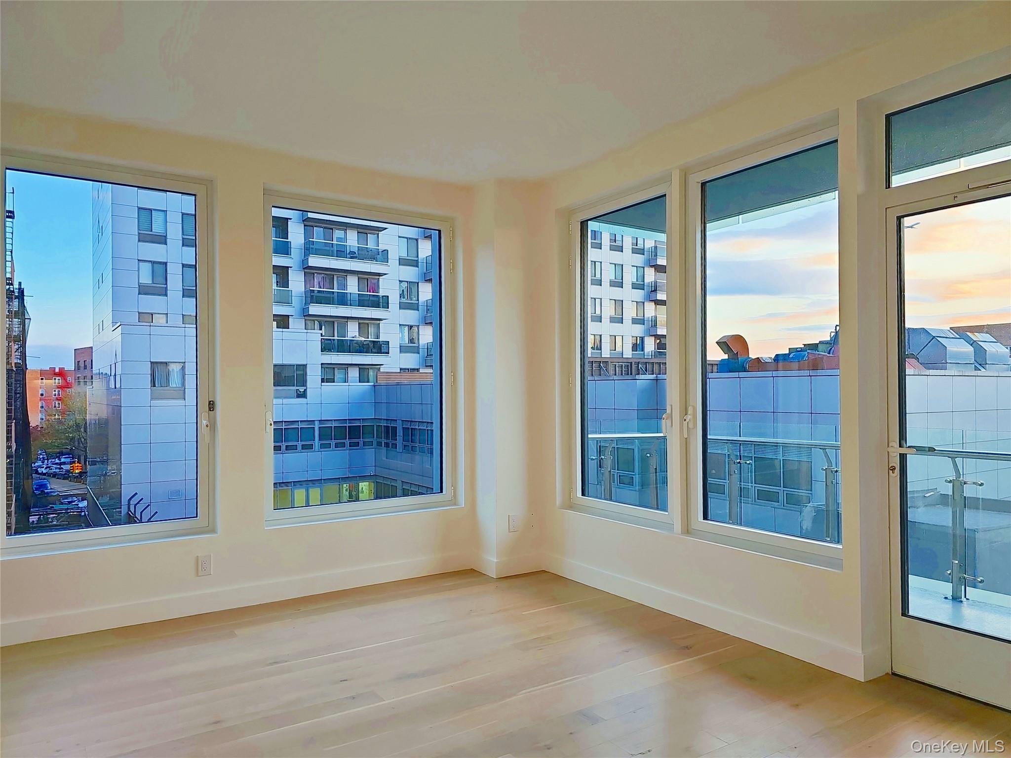 136-18 Maple Avenue, Unit 5B Queens, NY 11355 - Photo 25 of 31 a view of an empty room with glass windows