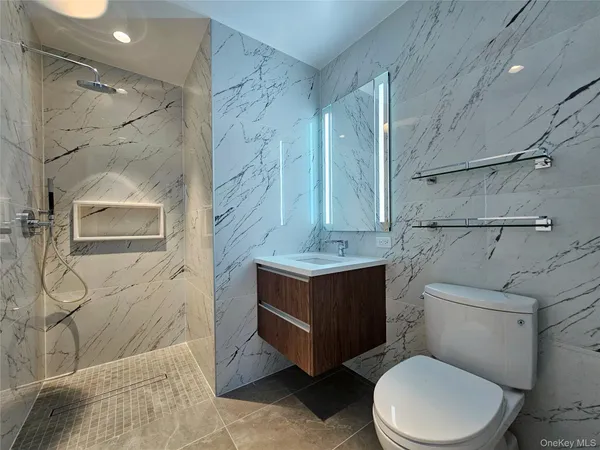 a bathroom with a toilet sink and shower