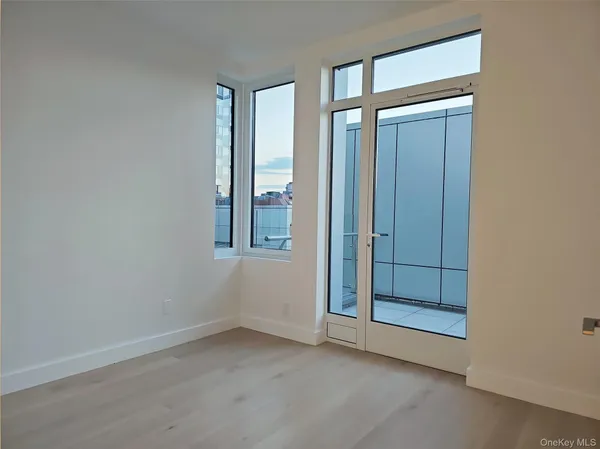an empty room with windows and closet