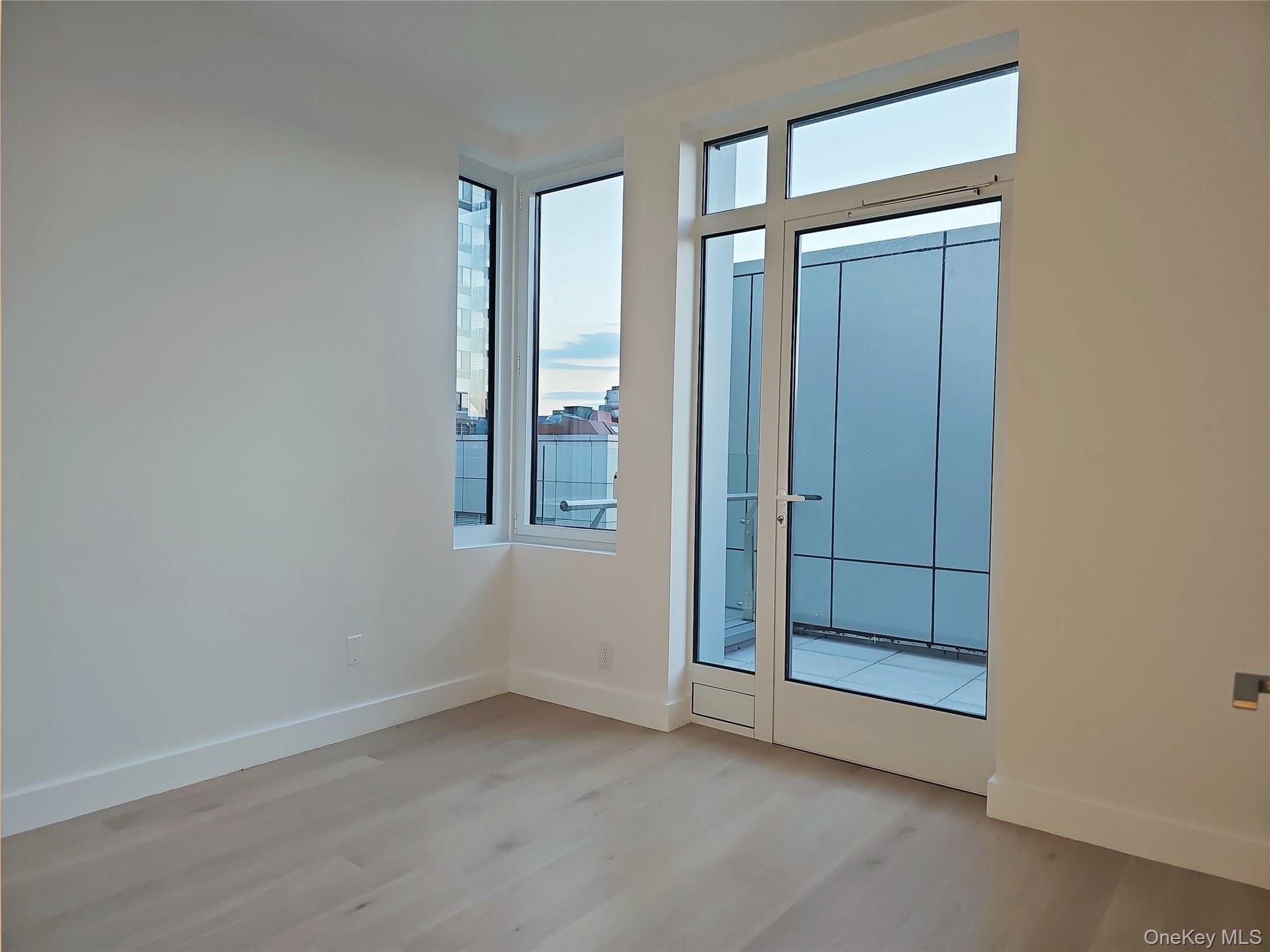 136-18 Maple Avenue, Unit 5B Queens, NY 11355 - Photo 28 of 31 an empty room with windows and closet
